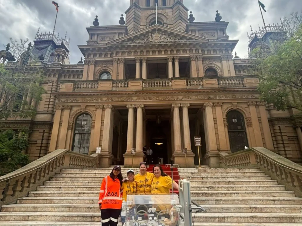 staff photo near big building